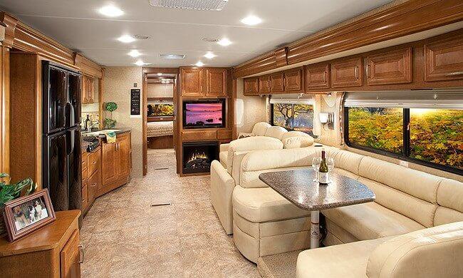 If your looking for amenities, space, storage & luxury then you will want to consider buying an RV from the Class A section. Class A RVs are top of the line, and can include as many features as you want. This is an interior pic of a Class RV a friend was considering when buying an RV out in Montana. As you can see there are two lazy boy recliners, a couch that folds out into a guest bed. Full size bathroom, kitchen and in this Class A RV there is a built in office complete with a desk. How many RVs do you know with a desk? If you need space then when buying an RV you need to consider a Class A Motorhome.
